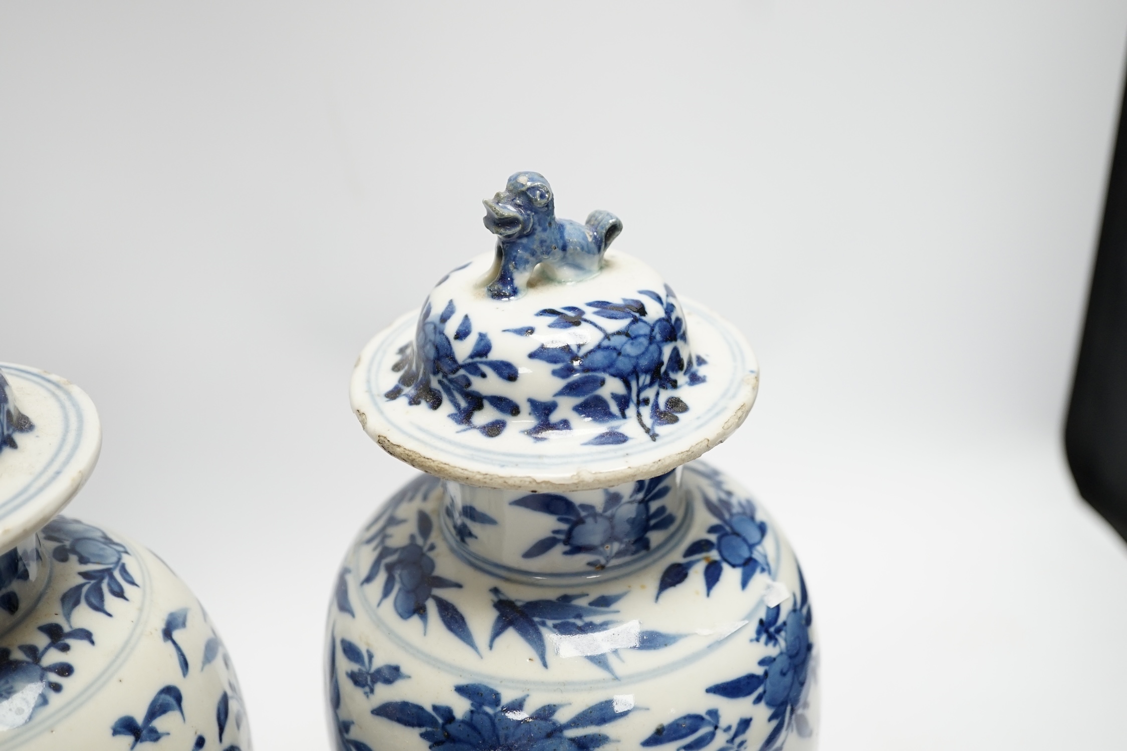 A pair Chinese blue and white vases, late 19th century, with lion-dog covers, 32cm high